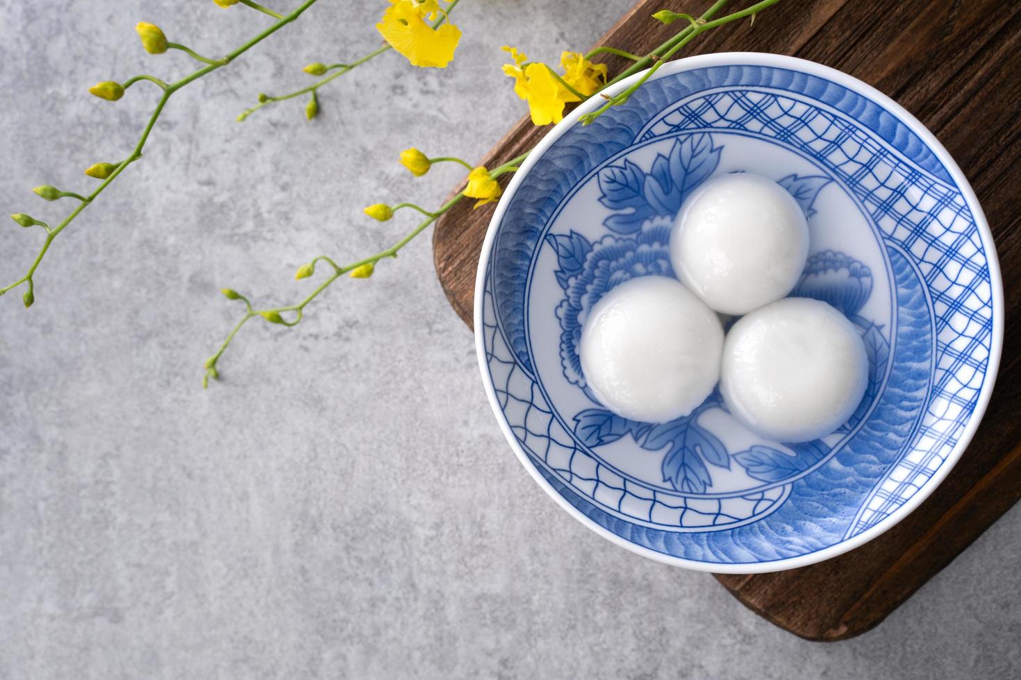 Top view of big tangyuan yuanxiao in a bowl on gray background for lunar new year food. photo