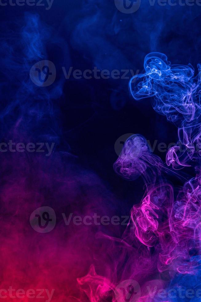 Conceptual image of colorful red and blue color smoke on dark black background. photo