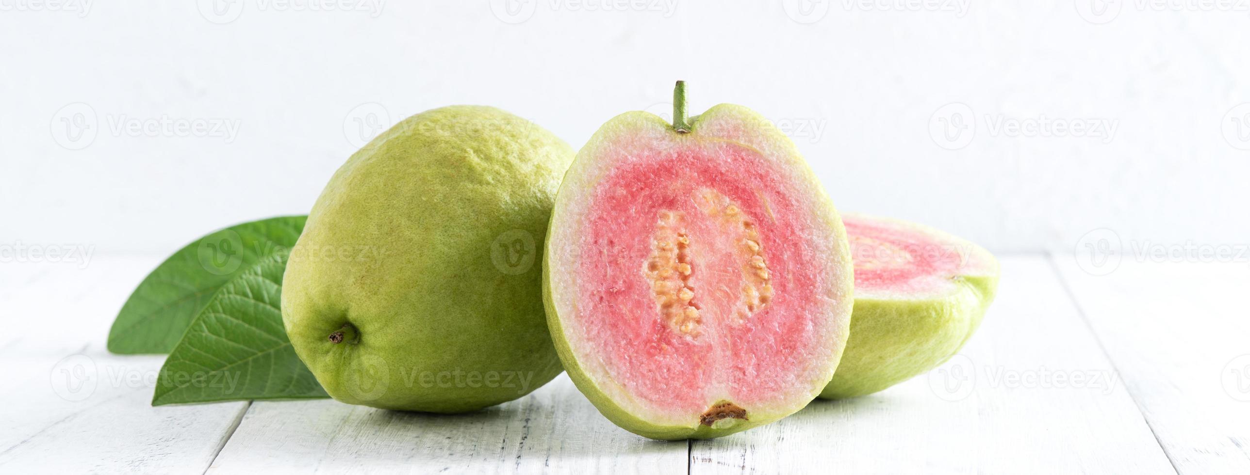 Top view of beautiful red guava with fresh green leaves. photo