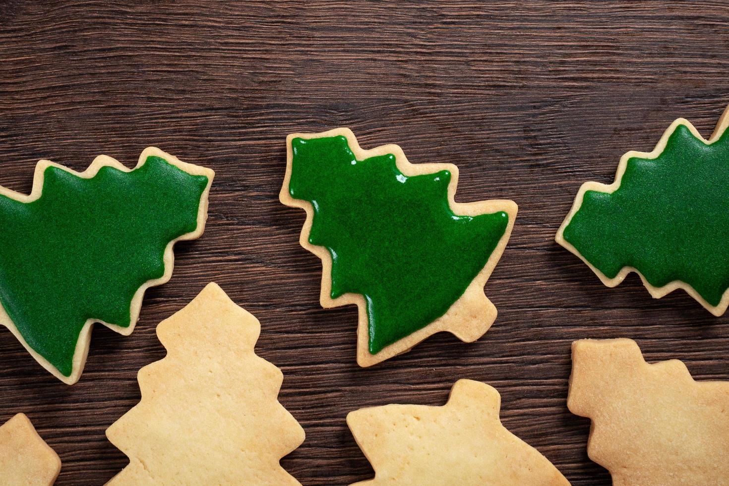Top view of decorated Christmas tree cookie on wooden table background with copy space. photo