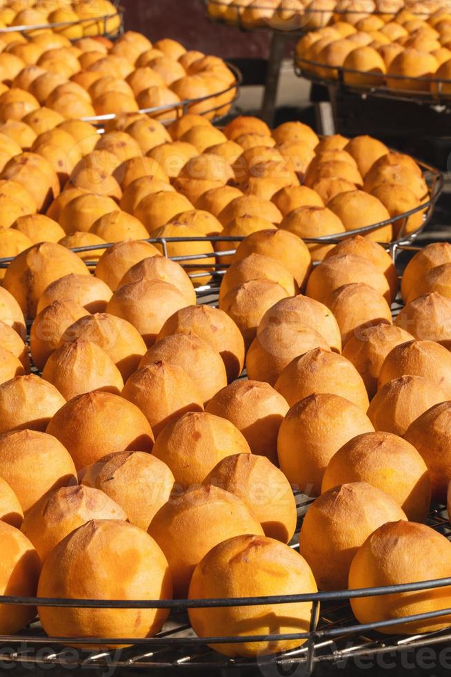 Making process of sun exposuring dried persimmon in a sieve in autumn. photo