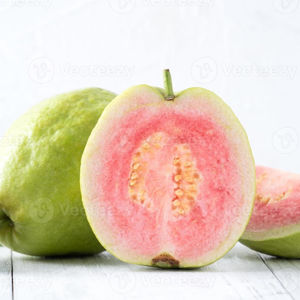 Top view of beautiful red guava with fresh green leaves. photo