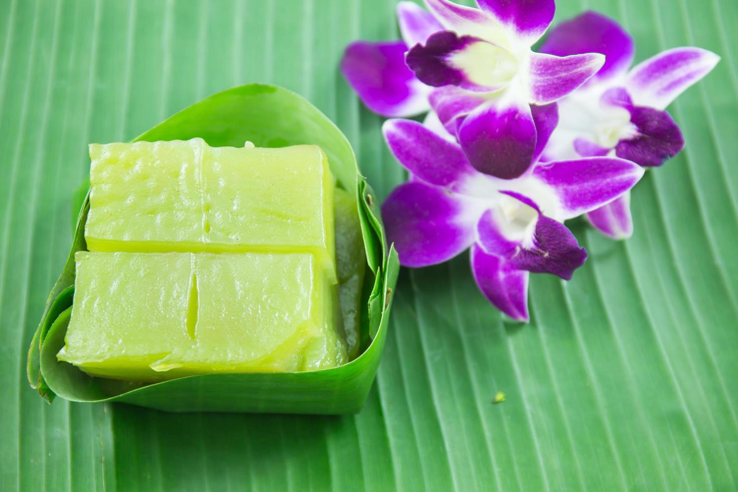 Kind of Thai sweetmeat, Multi Layer Sweet Cake Kanom Chan on banana leaf with orchid flower photo