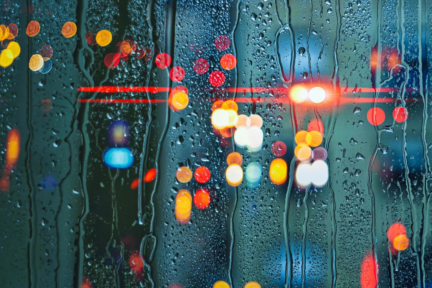 drops on the window and street lights background photo