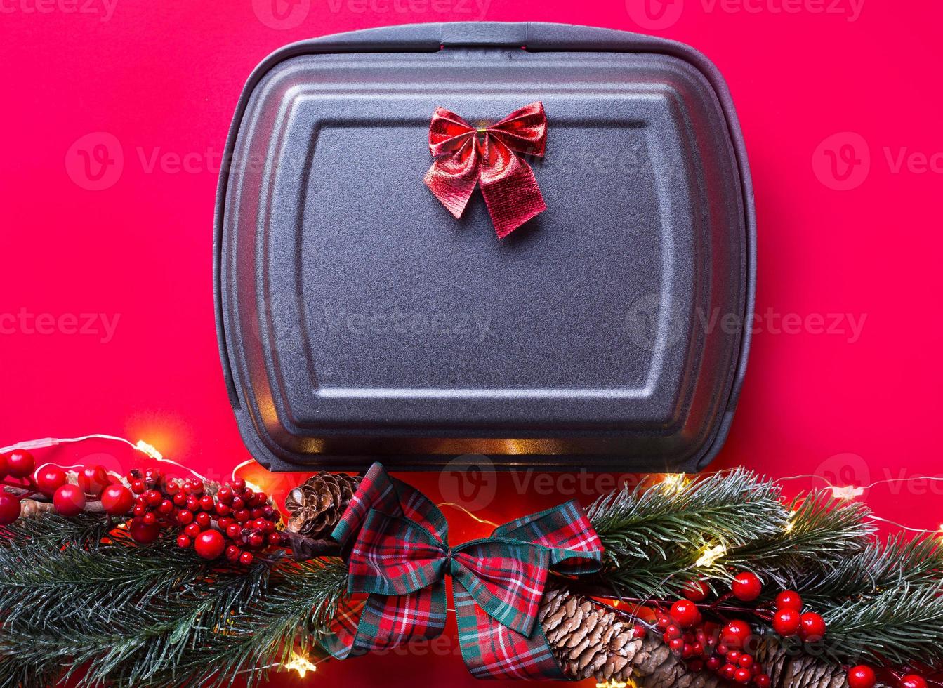 Christmas decor of food delivery service containers. New year's eve promotion. Ready-made hot order, disposable plastic and paper packaging. Work on public holidays catering. Copy space, mock up photo