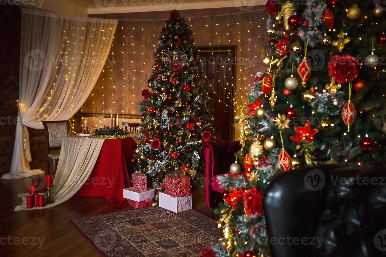 Christmas interior of the dark living room of the house. Christmas tree, lights of garlands on the walls, library Cabinet, books on the shelves. Luxury interior. New Year, red and gold balls. photo