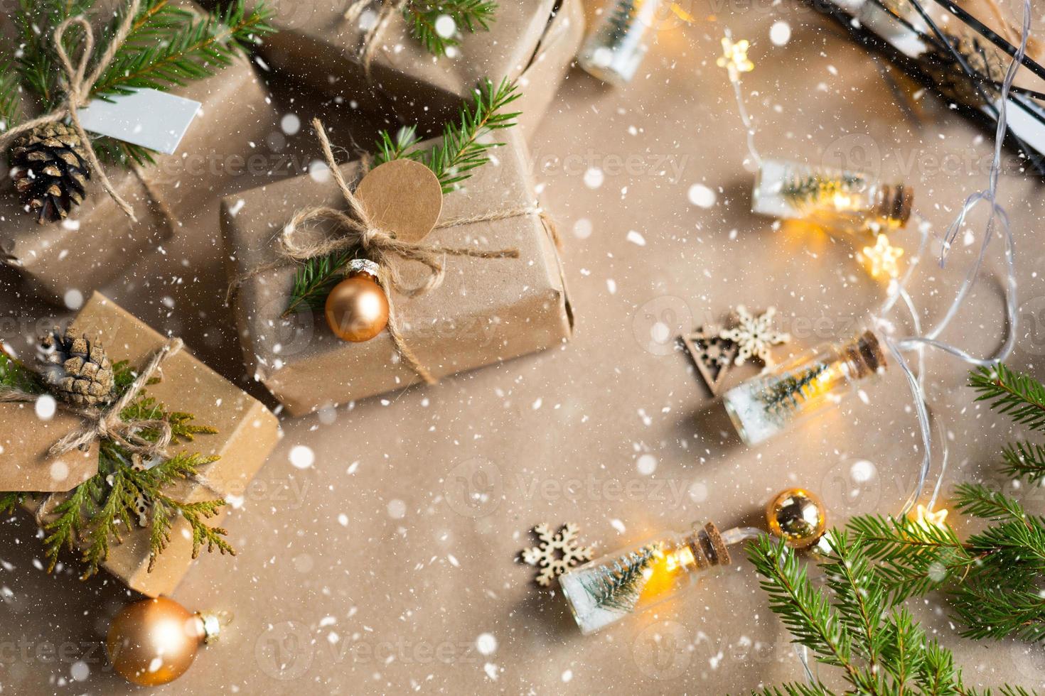 Pack a gift for Christmas and new year in eco-friendly materials kraft paper, live fir branches, cones, twine, snow. Tags with mock up, natural decor, hand made, DIY. Festive mood. Flatly, background photo