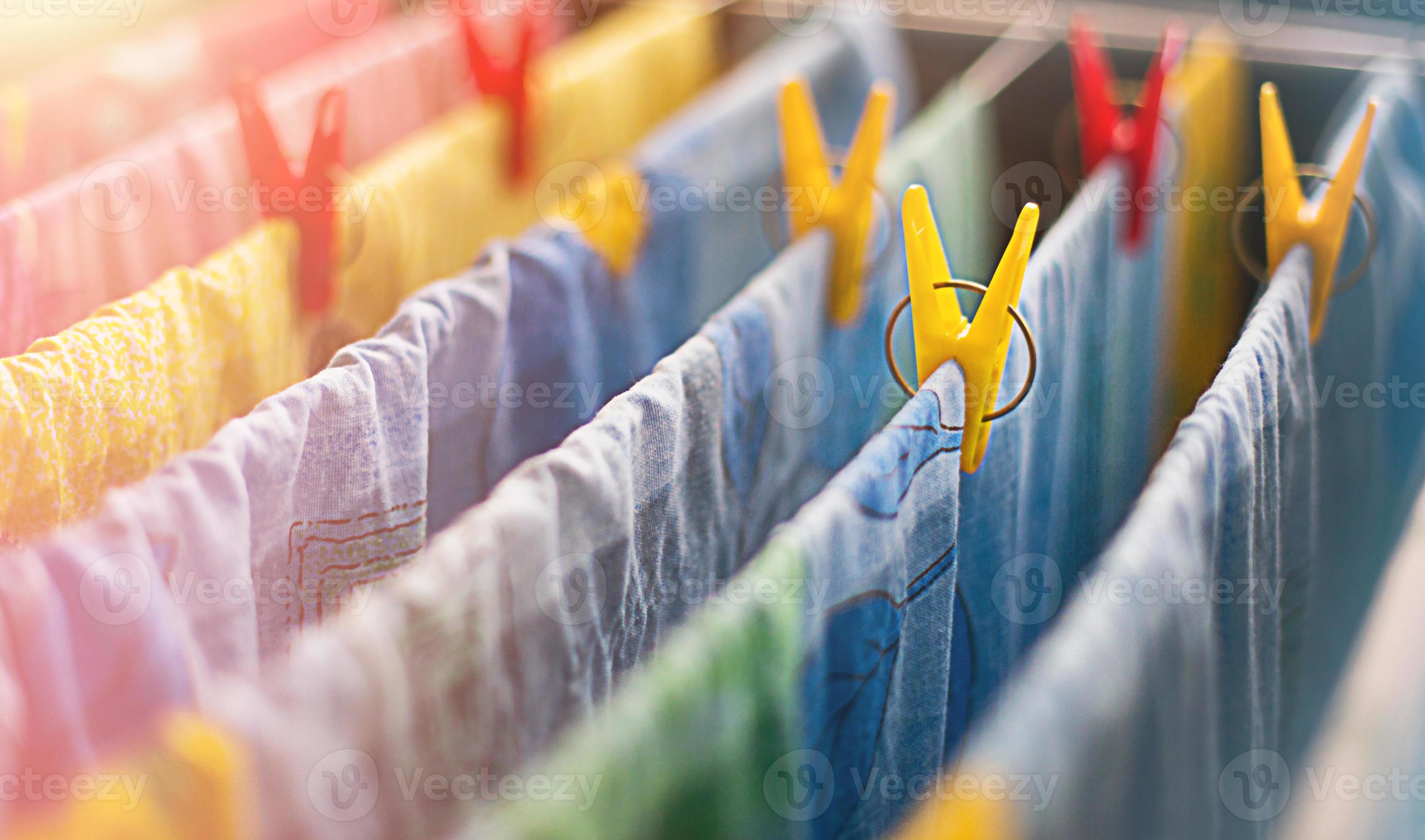 Colorful clean bed linen and towels after washing are hung on the bars