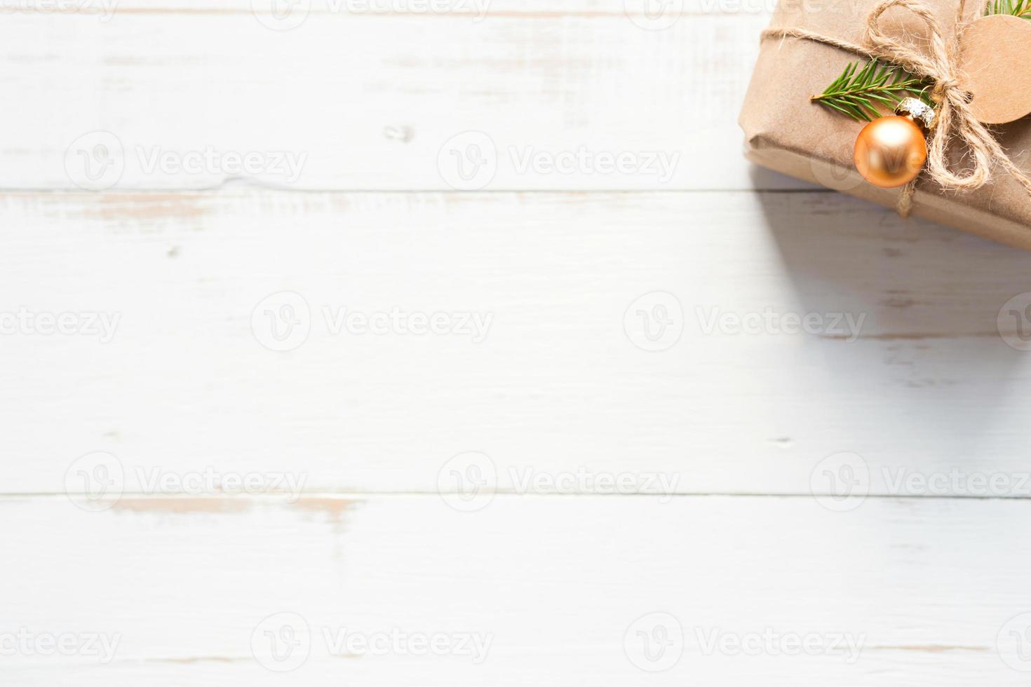 Gift box for Christmas and new year in eco-friendly materials kraft paper, live fir branches, cones, twine. Tags with mock up, natural decor, hand made, DIY. Flatly, background, frame, Minimalism photo