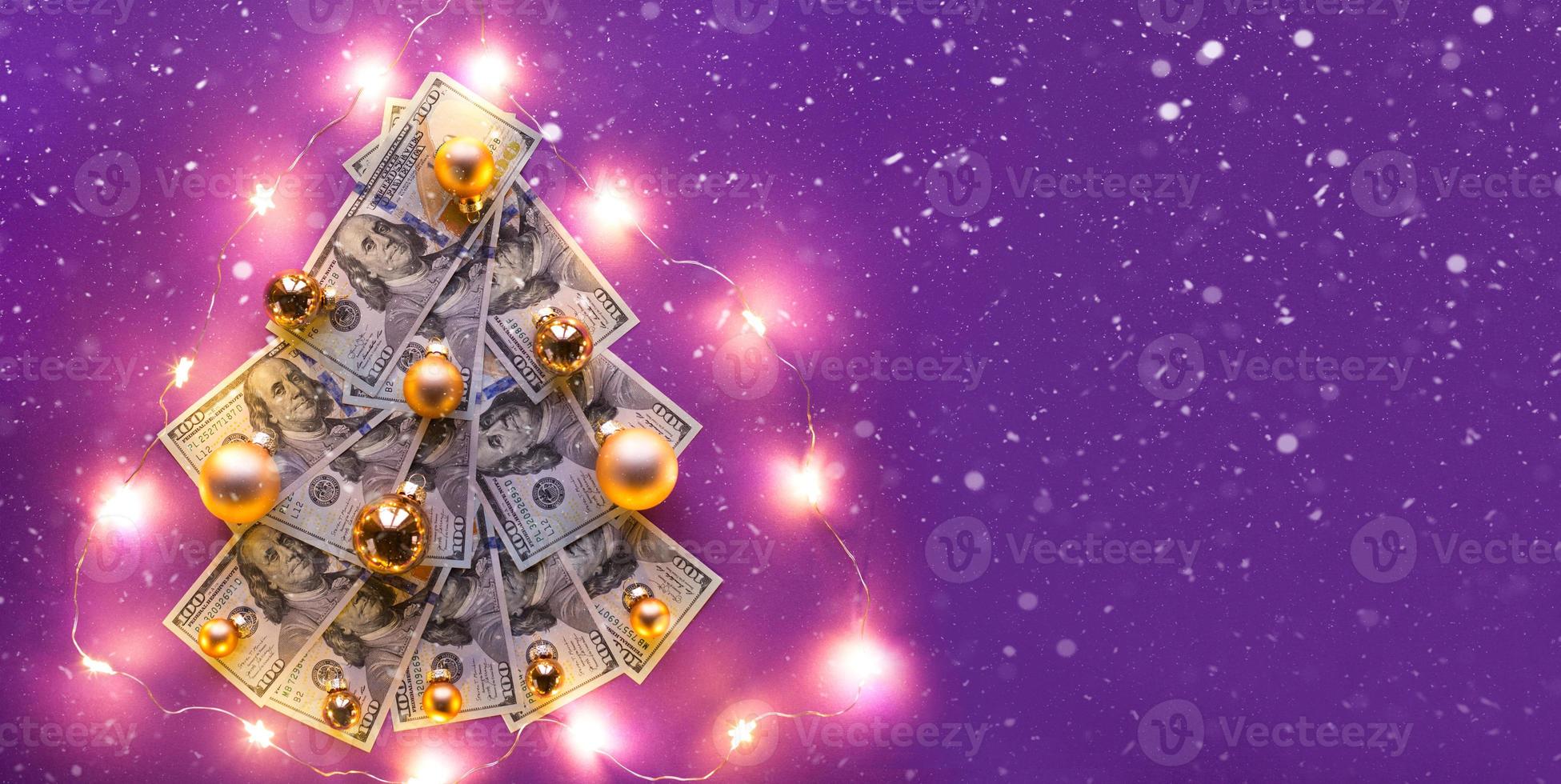 Christmas tree of 100 dollar bills on purple background with copyspace and snow, fairy lights. Decor of finance, savings, wealth, expenses in new year. Flatly. Stack of 100, Investments, business photo