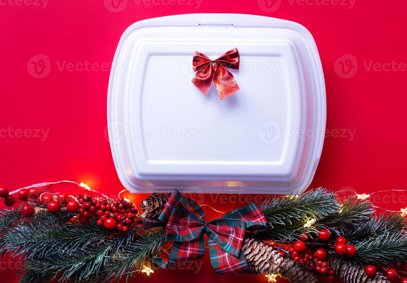 Christmas decor of food delivery service containers. New year's eve promotion. Ready-made hot order, disposable plastic and paper packaging. Work on public holidays catering. Copy space, mock up photo