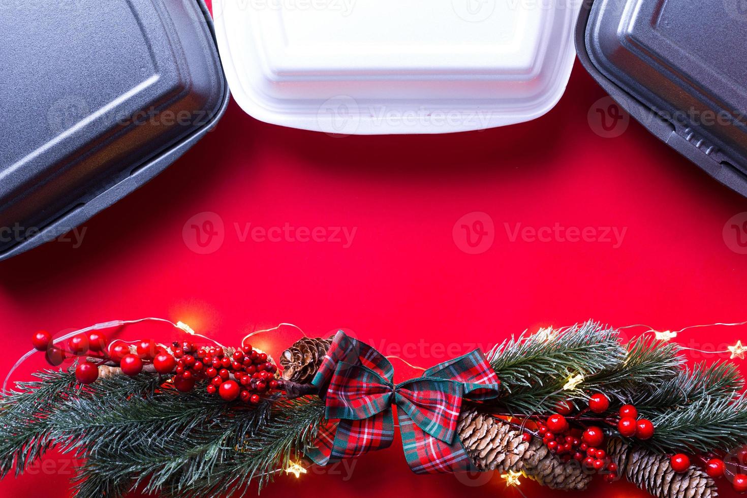 Christmas decor of food delivery service containers. New year's eve promotion. Ready-made hot order, disposable plastic and paper packaging. Work on public holidays catering. Copy space, mock up photo