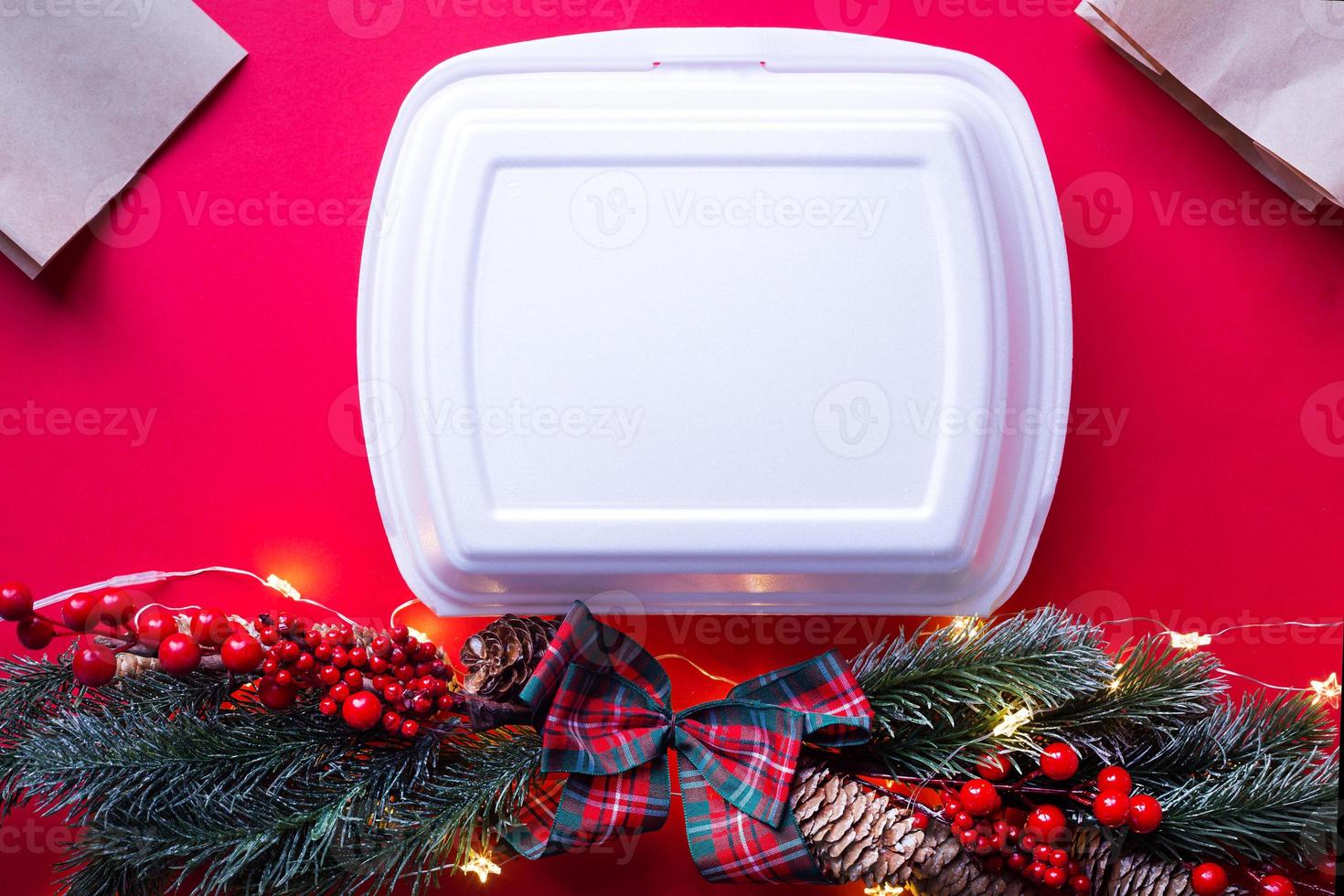 Christmas decor of food delivery service containers. New year's eve promotion. Ready-made hot order, disposable plastic and paper packaging. Work on public holidays catering. Copy space, mock up photo