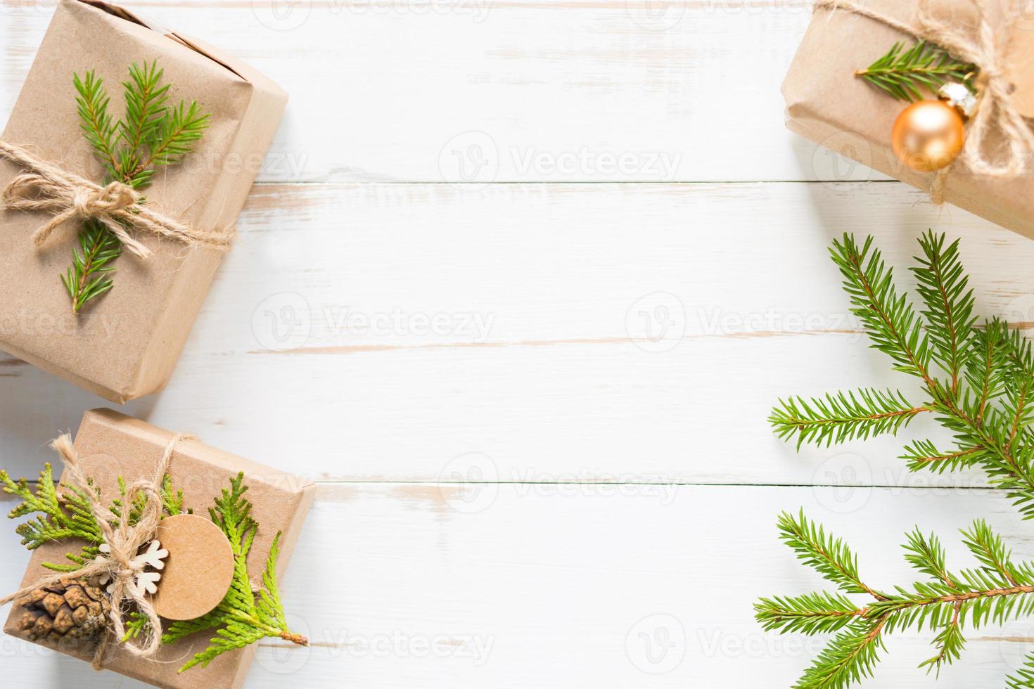 Gift box for Christmas and new year in eco-friendly materials kraft paper, live fir branches, cones, twine. Tags with mock up, natural decor, hand made, DIY. Flatly, background, frame, Minimalism photo