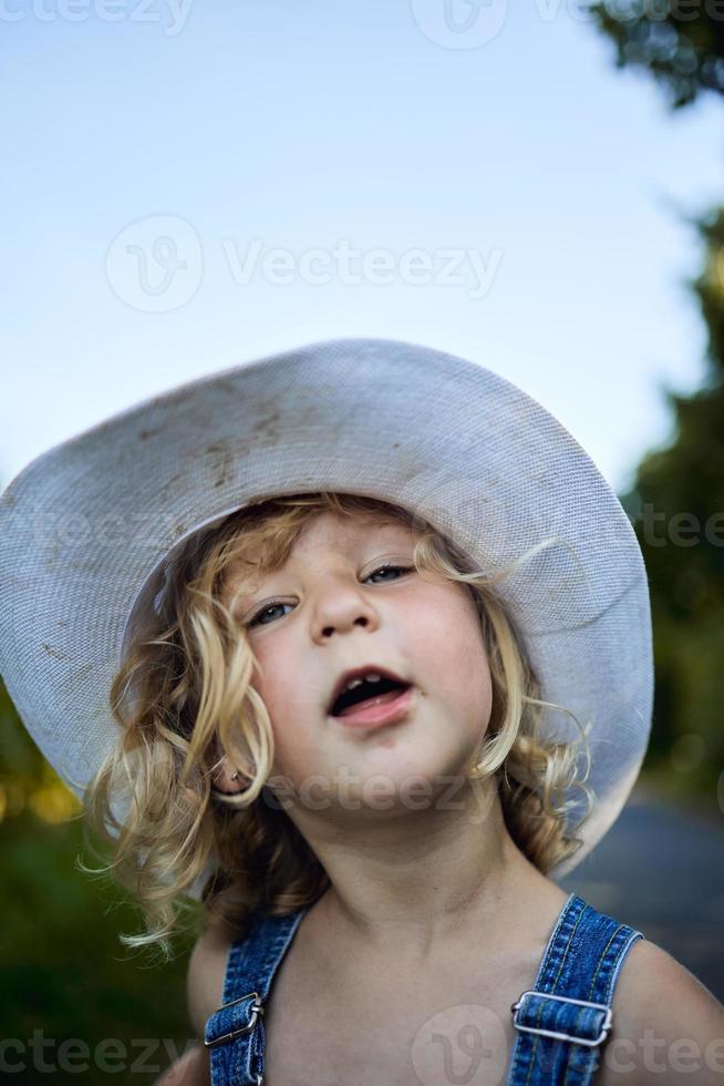 Little blonde girl playing on countryside photo