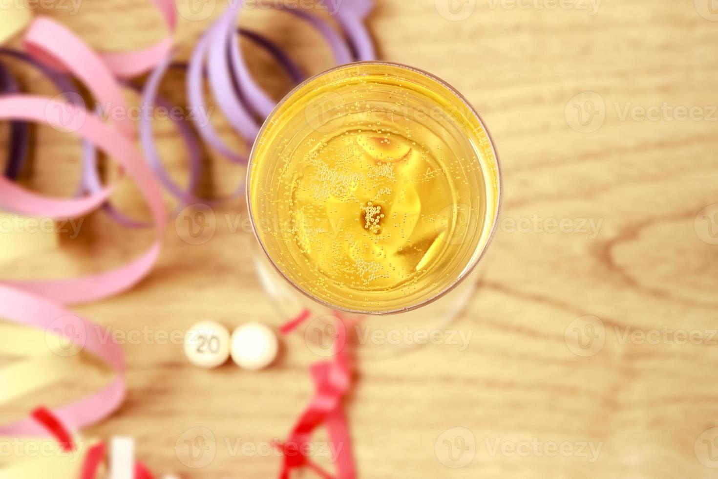 Party Decorations New Year's Eve with champagne on a parquet floor, with a white ball without a number, to put the year you want. Horizontal image. photo