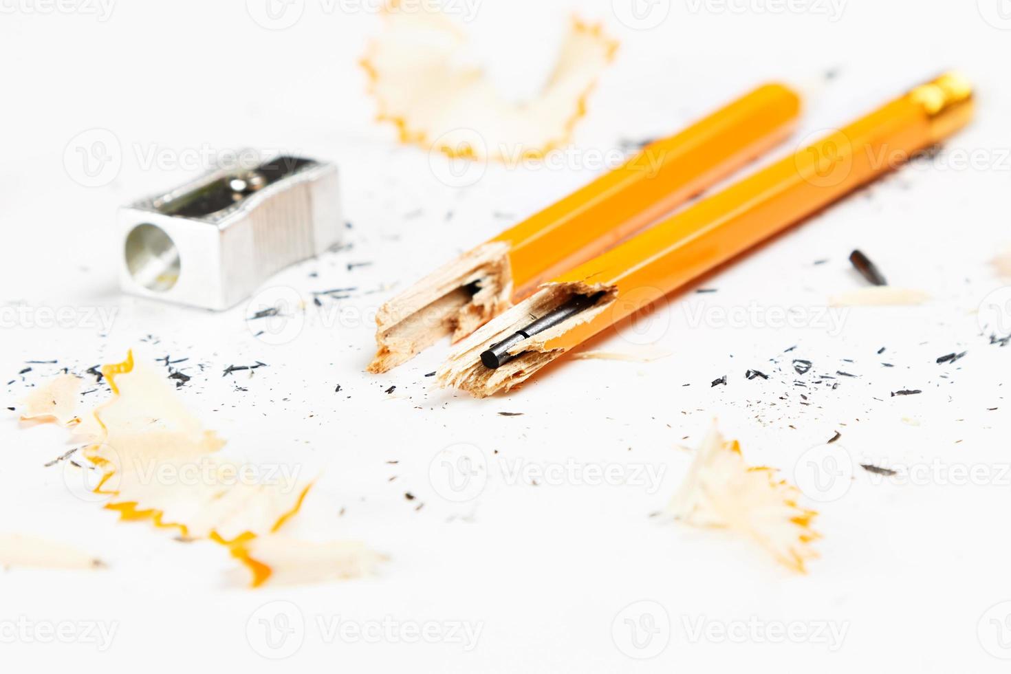 Pencil, metal sharpener and pencil shavings on white background. Horizontal image. photo