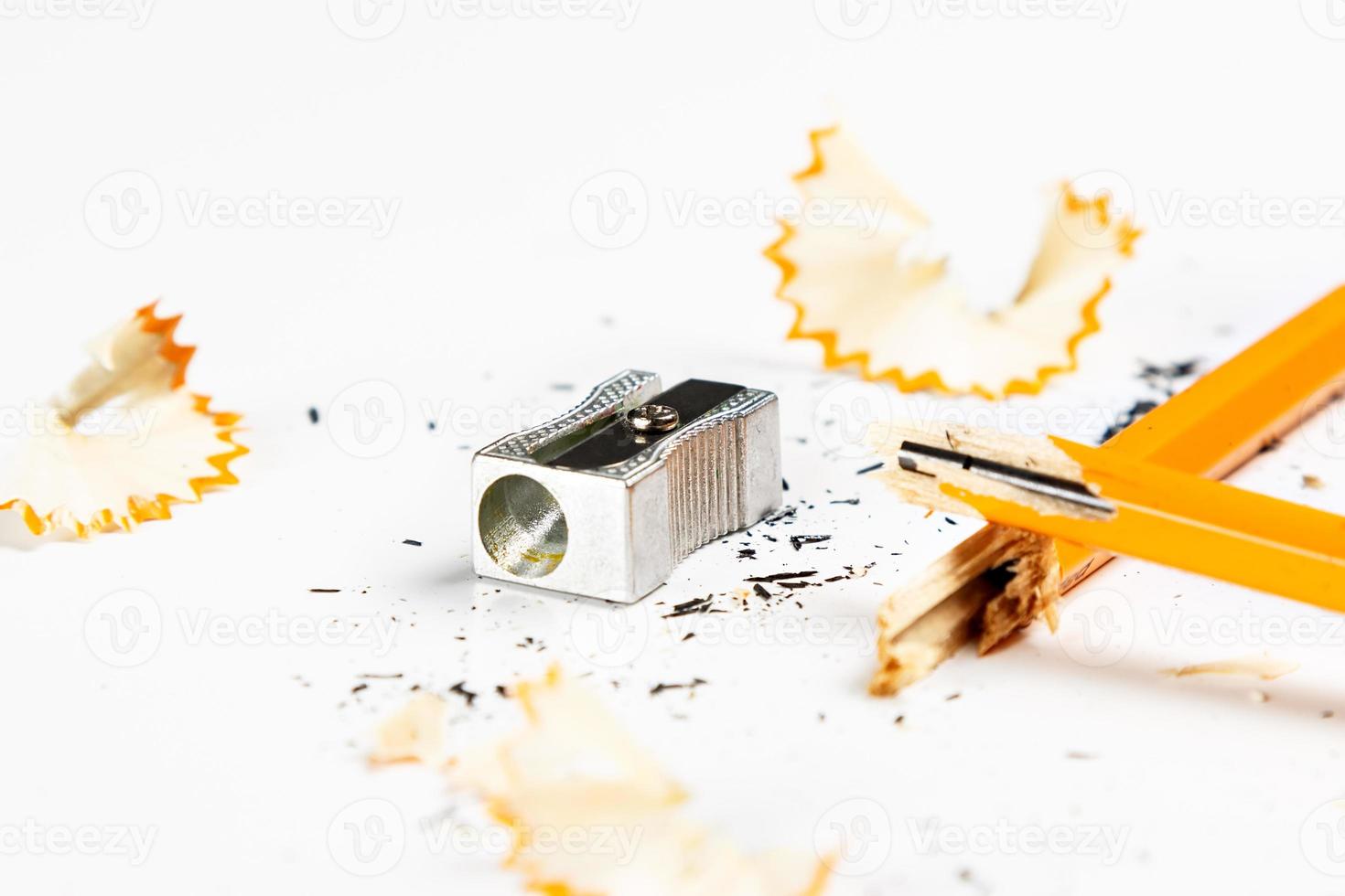 Pencil, metal sharpener and pencil shavings on white background. Horizontal image. photo