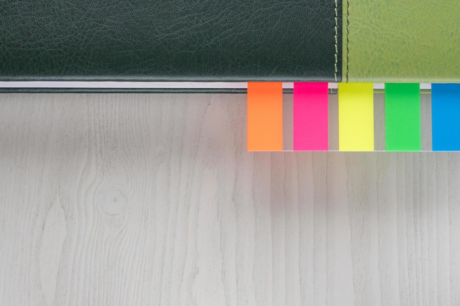 personal organizer with multicolored bookmarks on wooden table closeup photo