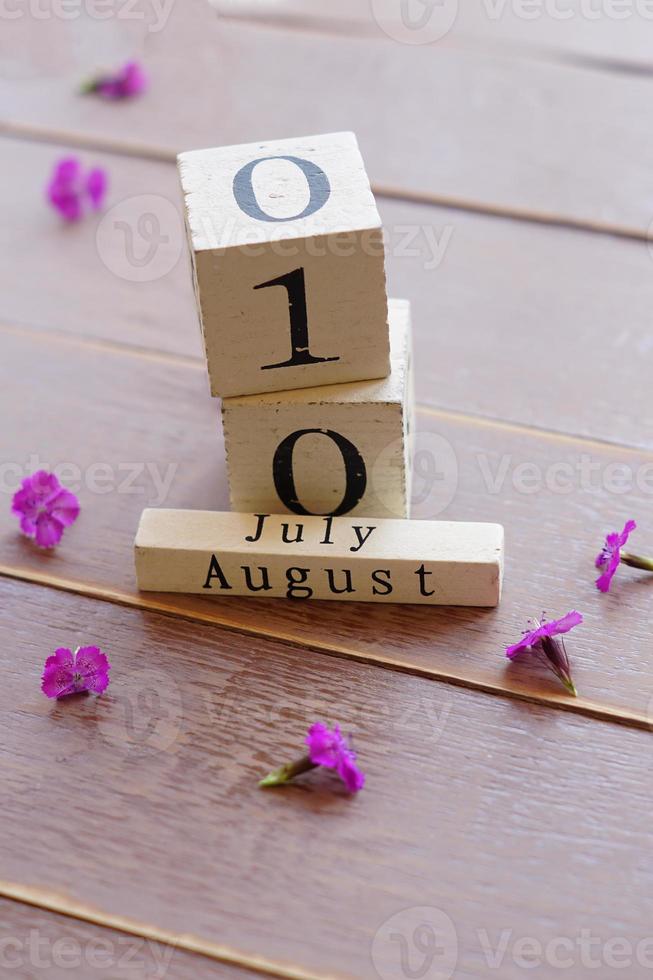 first day of July, colorful background with calendar and pink flowers photo