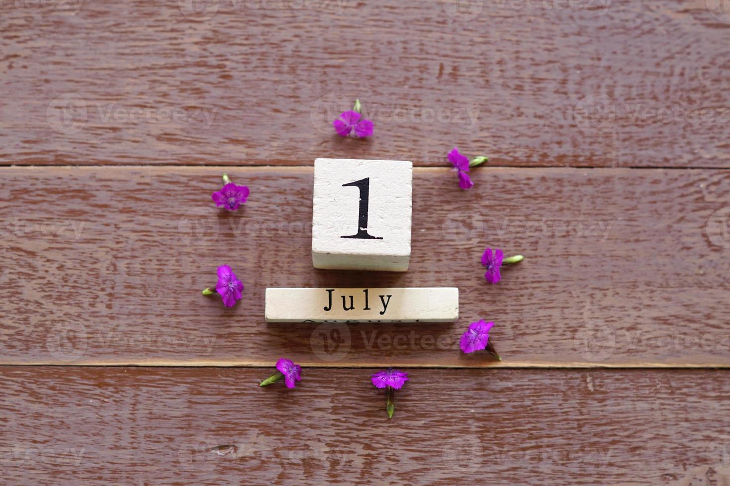 first day of July, colorful background with calendar and pink flowers photo