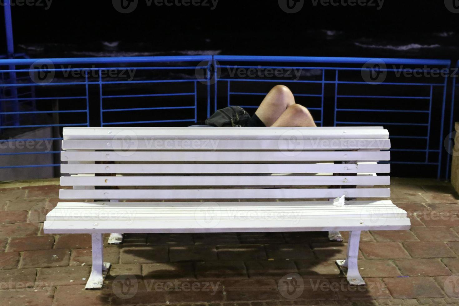 Bench for rest in the city park on the seashore. photo