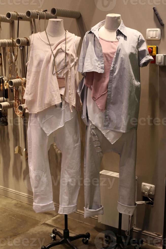 A mannequin stands on a showcase in a large store. photo