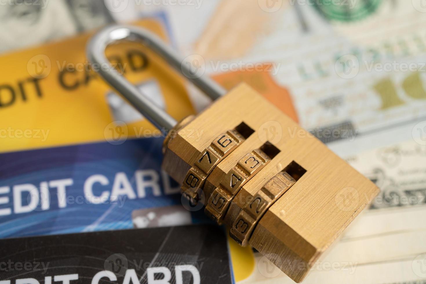 Credit card with password key lock security on US dollar background. photo