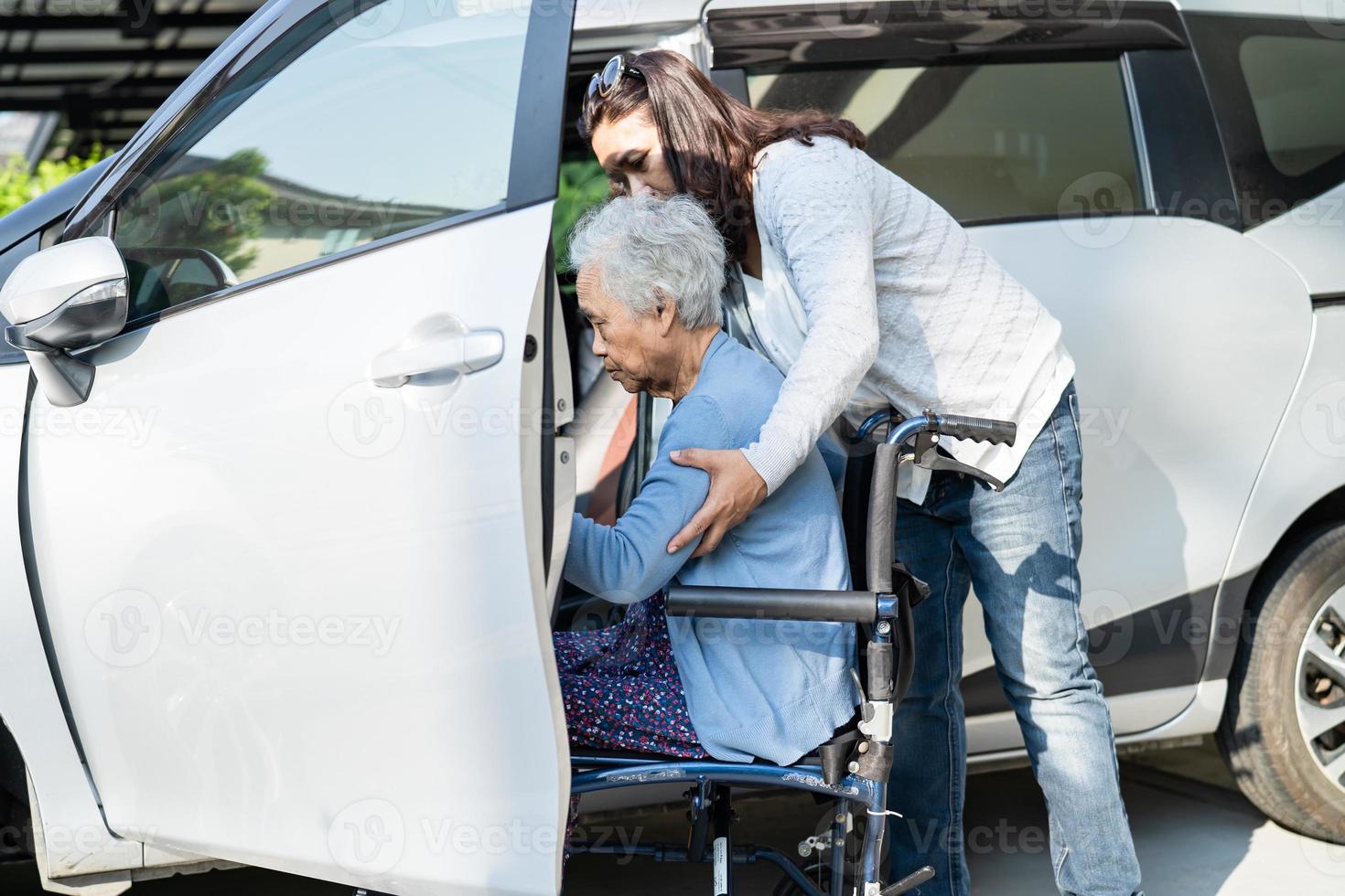 Asian senior or elderly old lady woman patient sitting on wheelchair prepare get to her car, healthy strong medical concept. photo