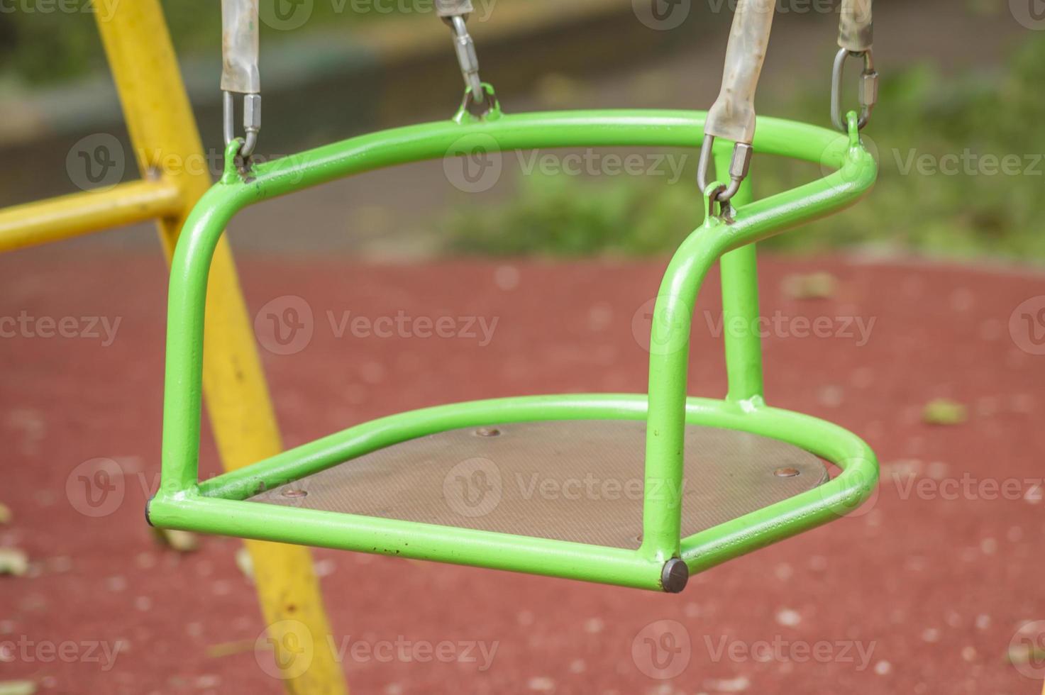 Closeup of Empty metal swing in playground photo