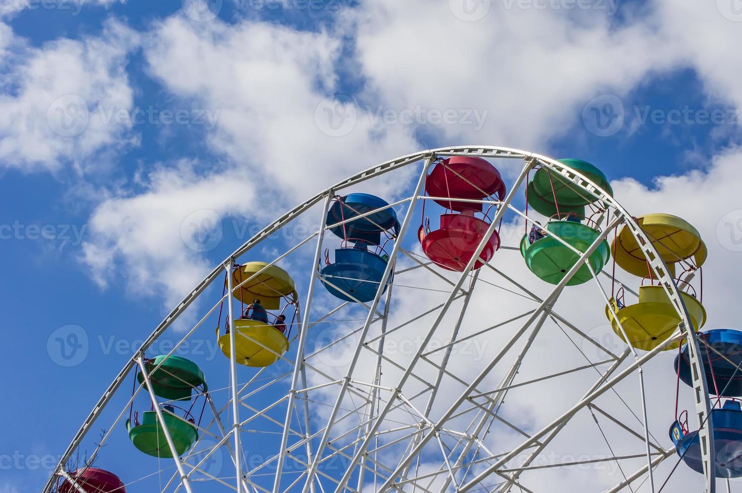 colorful ferris wheel against blue sky with clouds photo