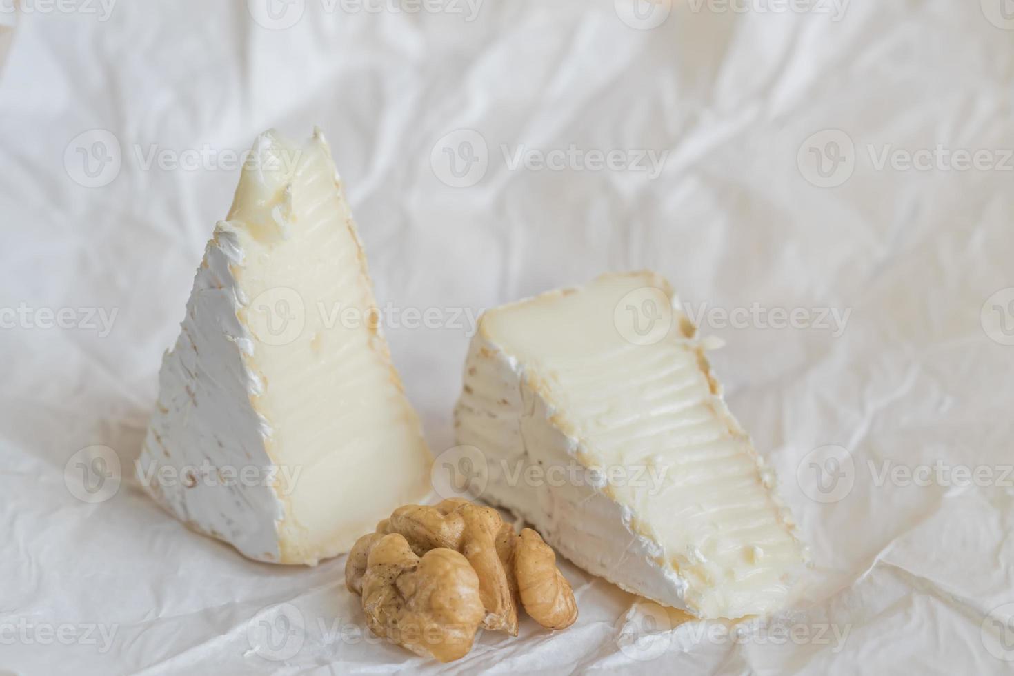 camembert and walnut on wooden background photo