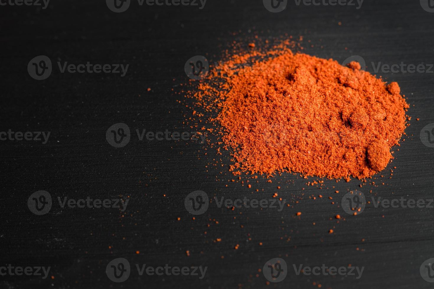 paprika powder on black background photo