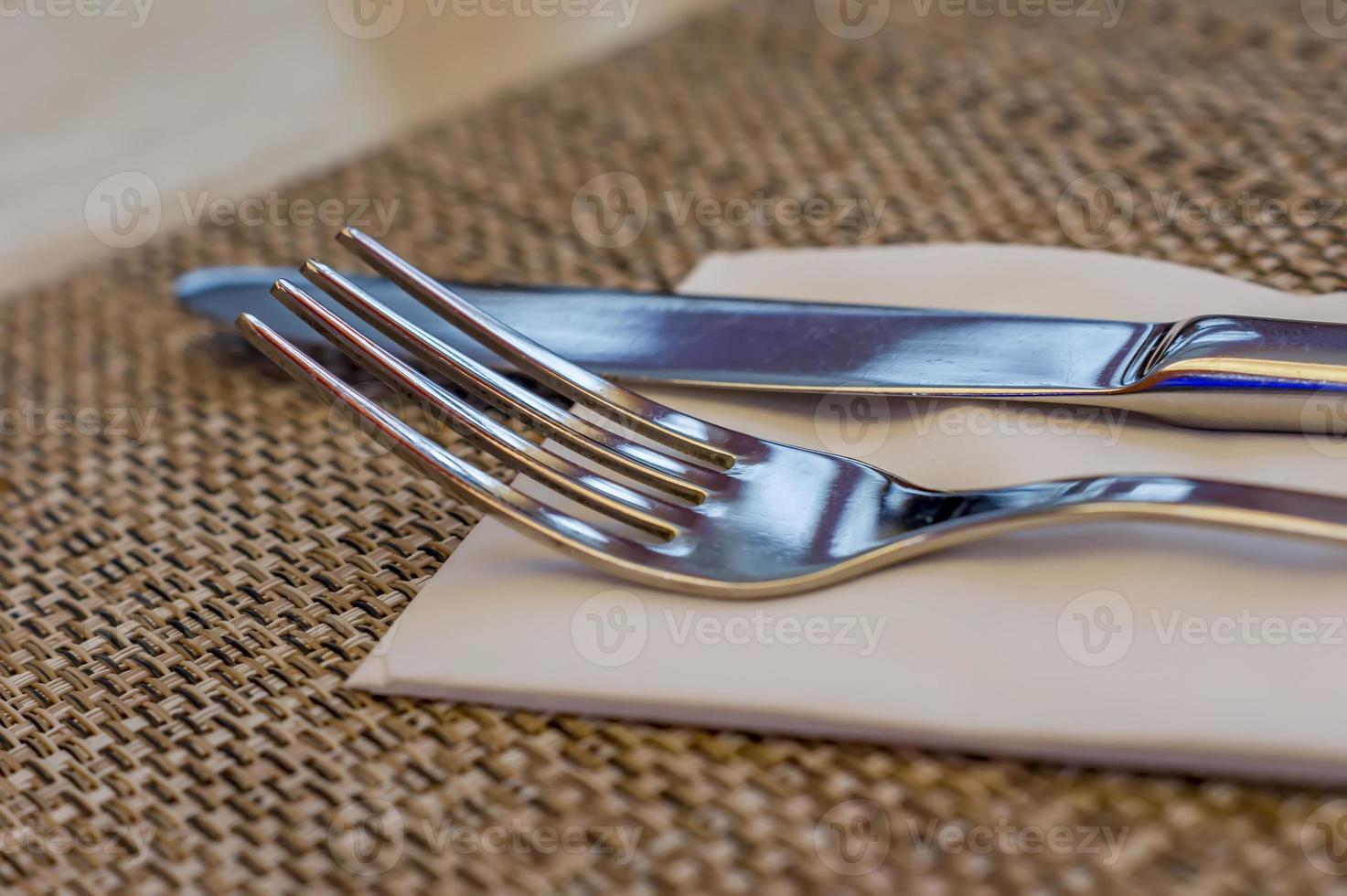 Served fork and knife on table. photo