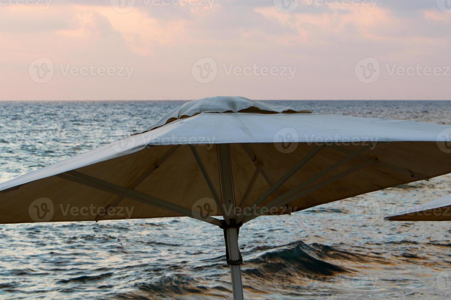 Umbrella for shelter from the sun on the city beach. photo