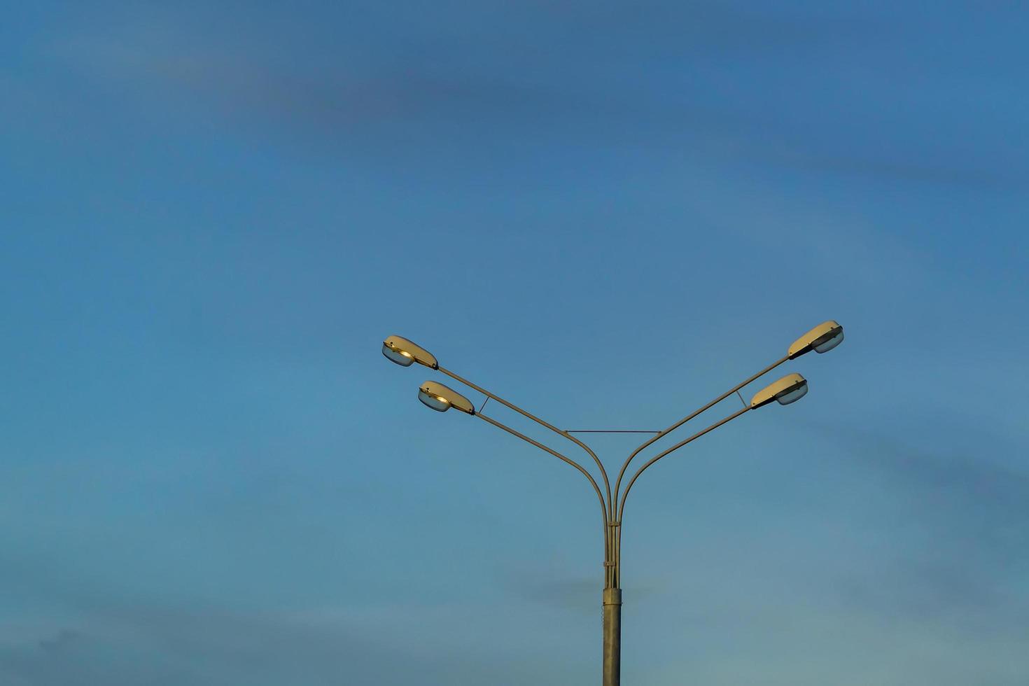 Street lamp post against sunset sky photo