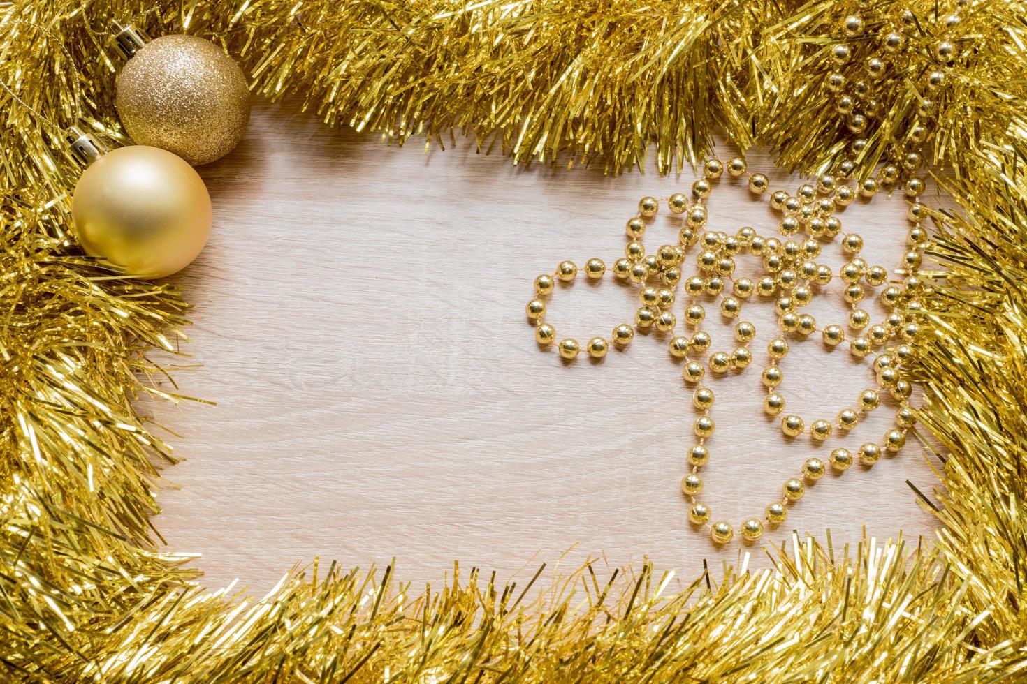 Christmas New Year holiday background. Golden tinsel and two sparkle balls. Copy space photo