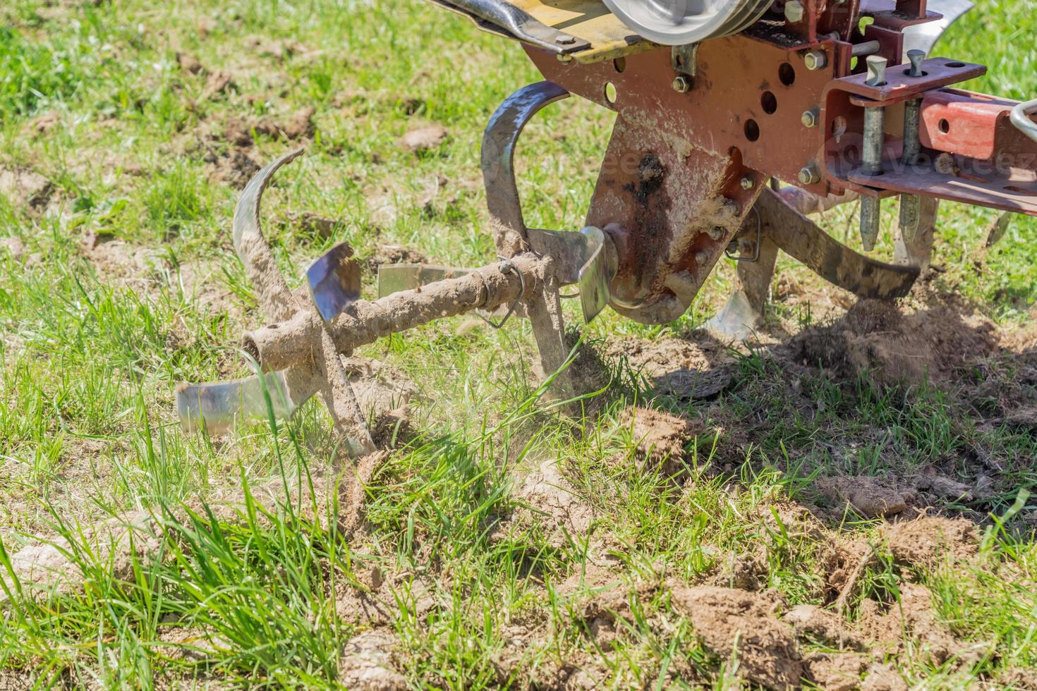 close up of small hand tractor motoblock for plowing field. photo