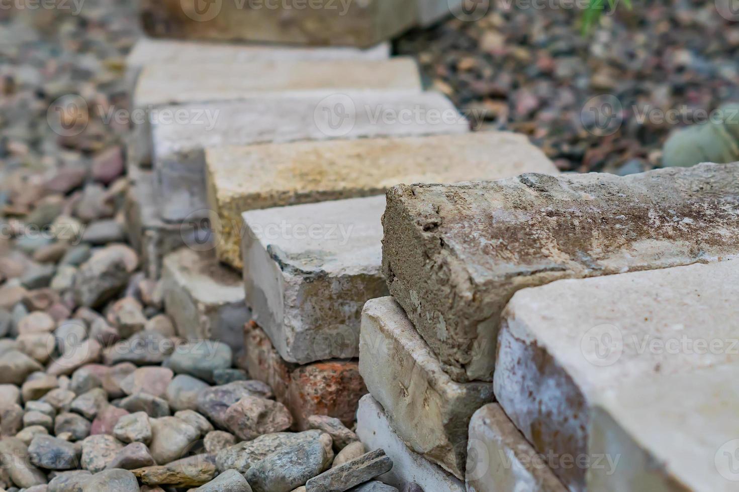 decorative fence made of old cement bricks in the garden photo