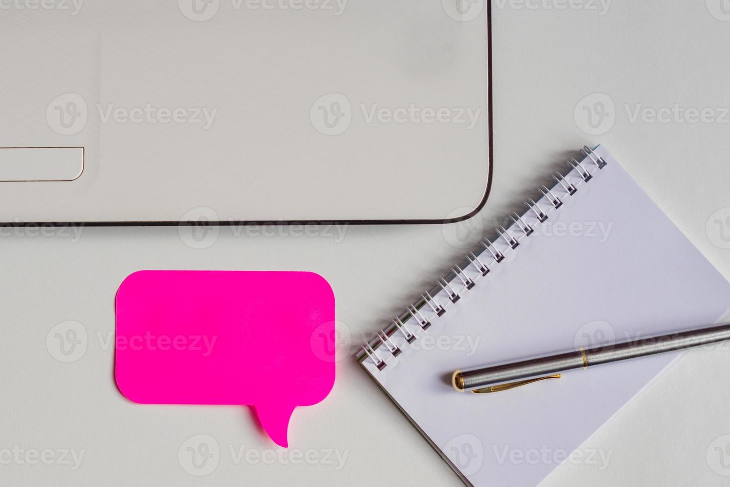 top view of white office desk, pink sticker for notes, laptop, pen and notebook, business mockup photo