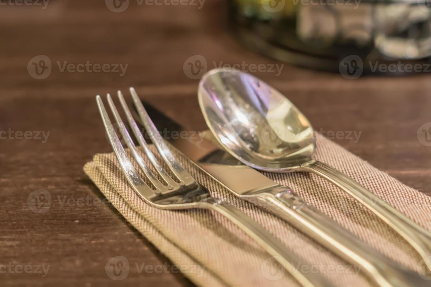Served fork, spoon and knife on table. photo
