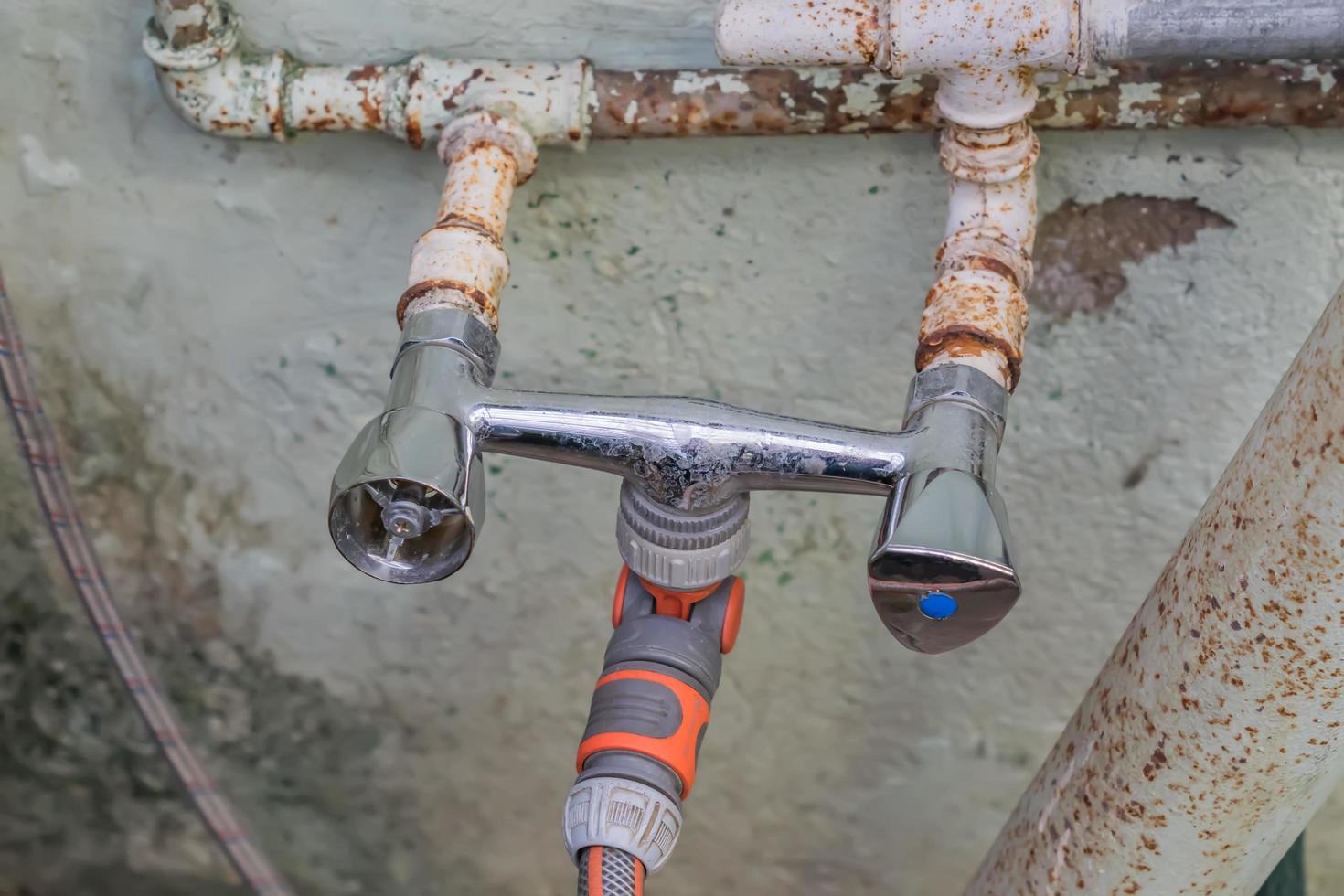 old rusty water tap for pouring plants photo