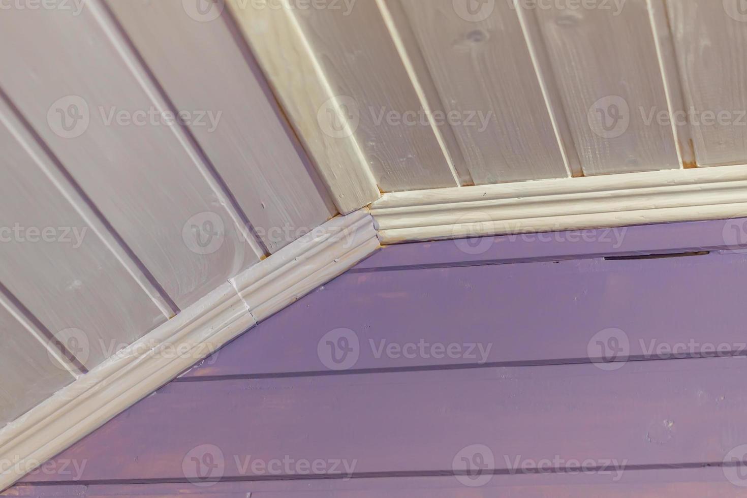 wooden wall and ceiling painted in purple. interior of country house photo