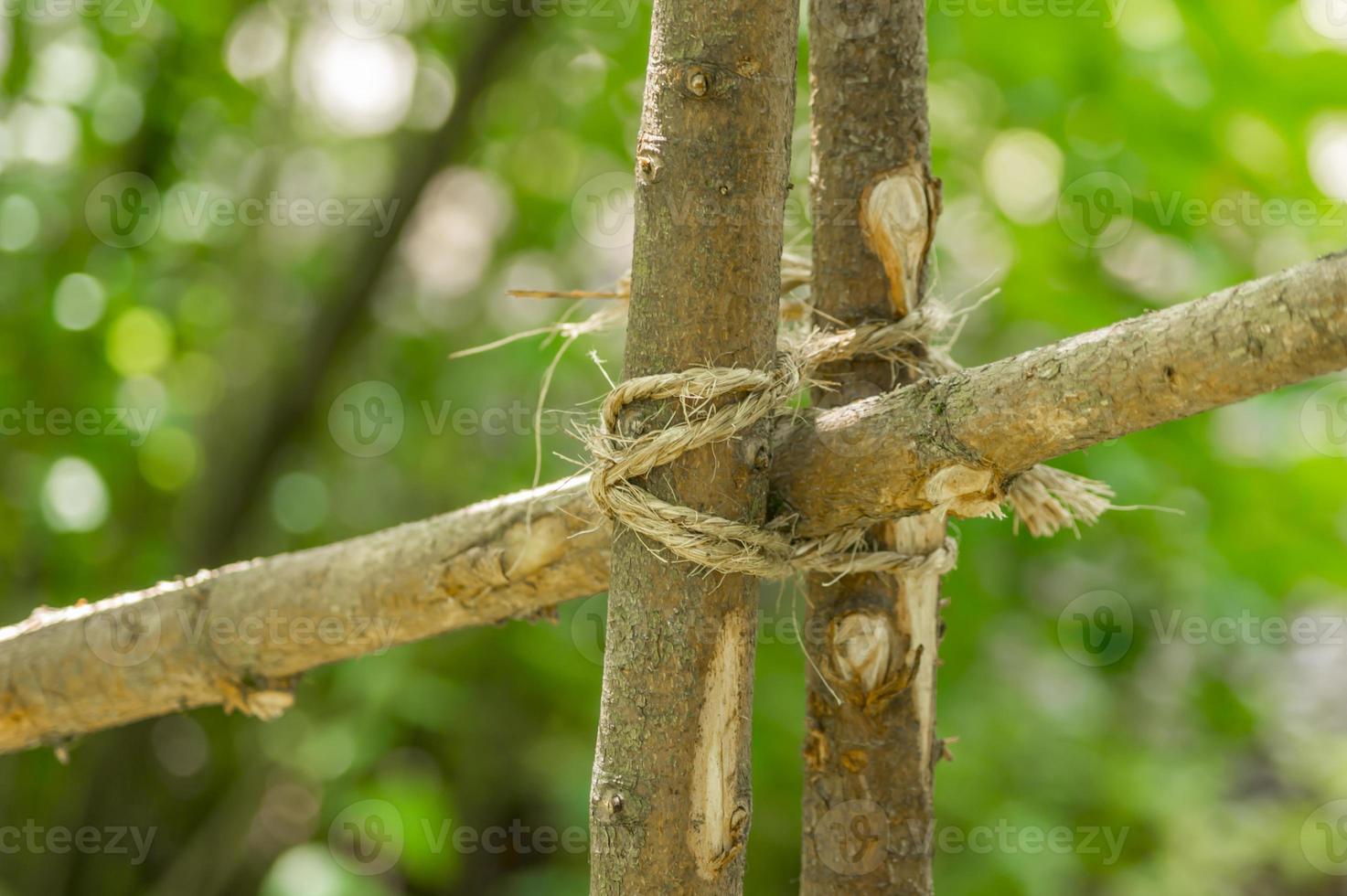 Closeup of handmade wooden fence made of branches. photo