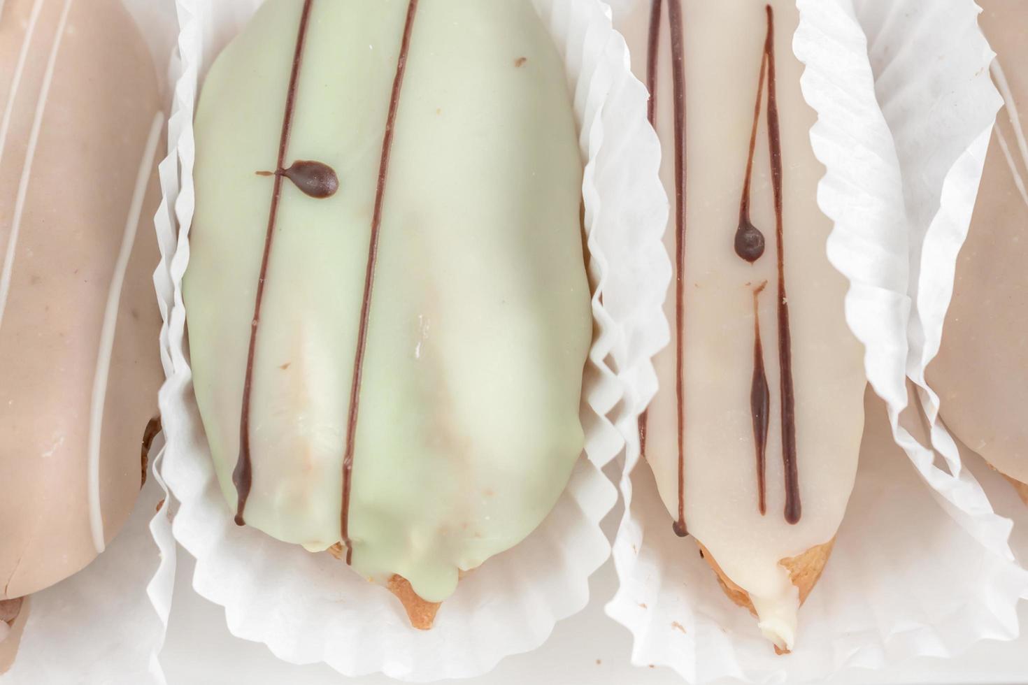closeup of french eclairs in color glaze photo