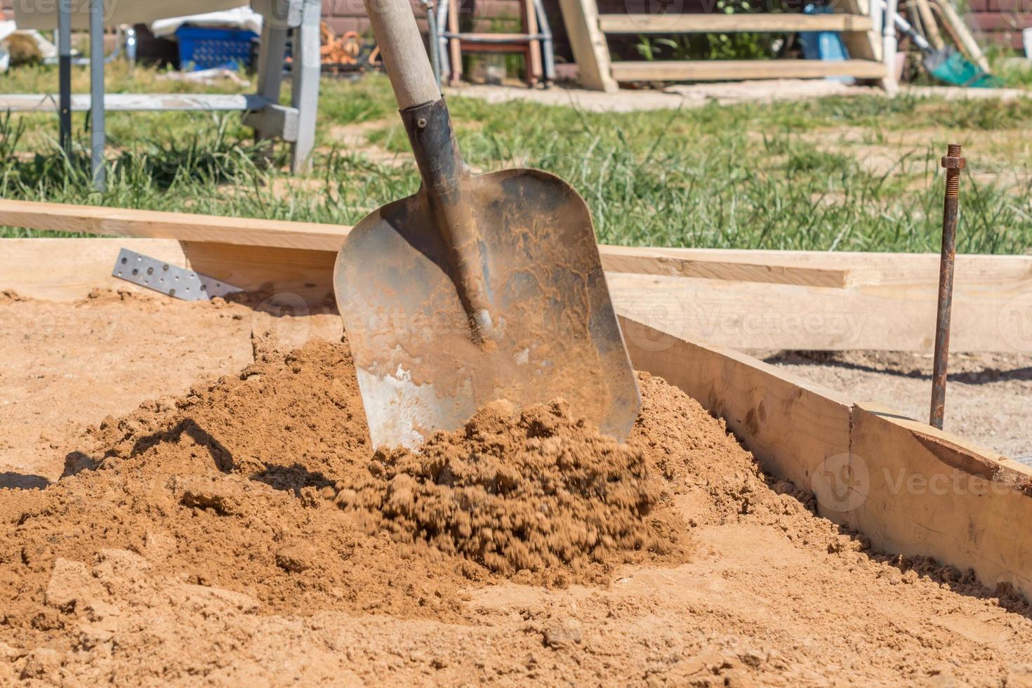 construction worker with a shovel, foundation preparation on construction site photo