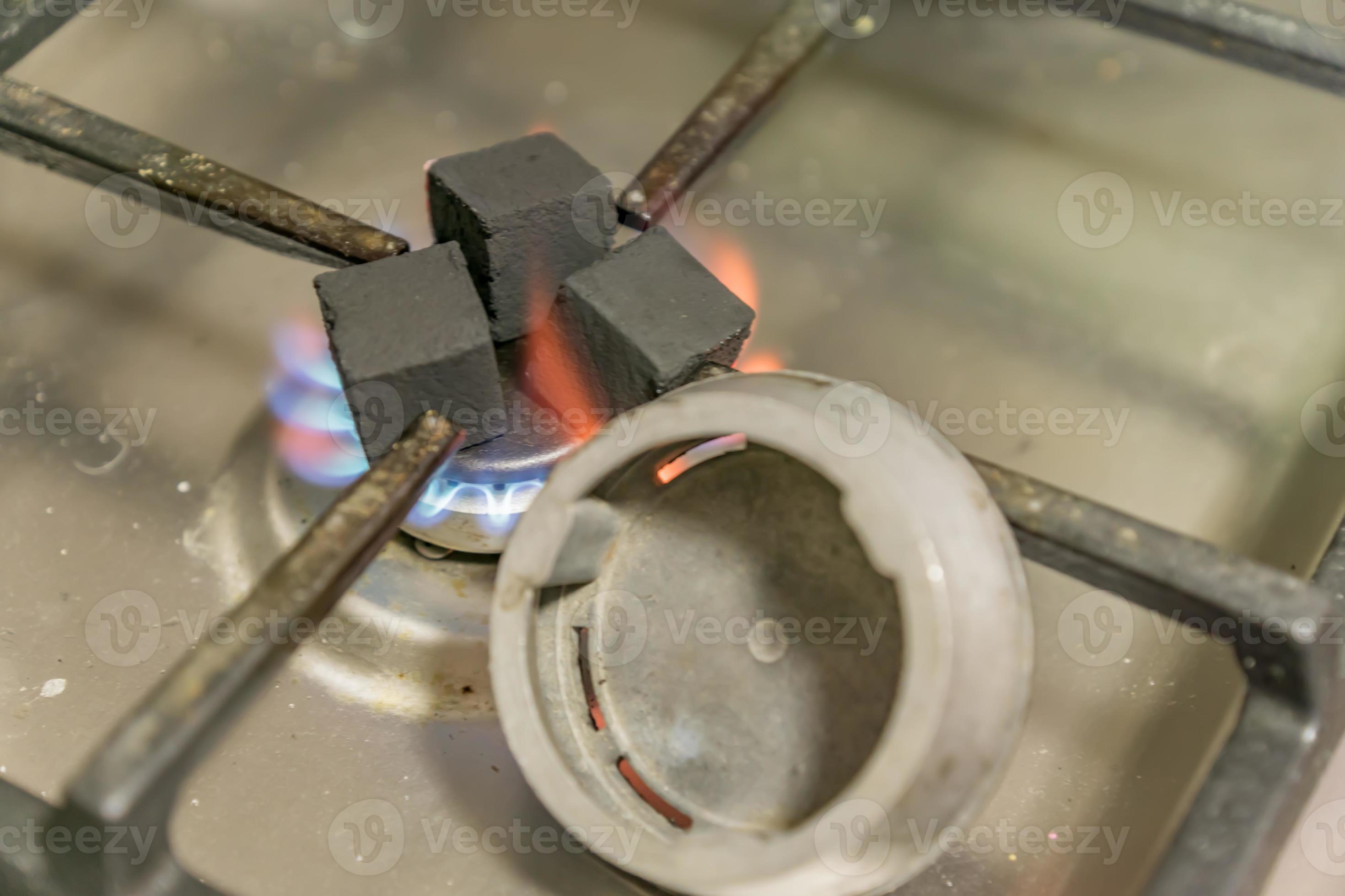 preparation of homemade hookah. heating of coals on a gas stove 9979605