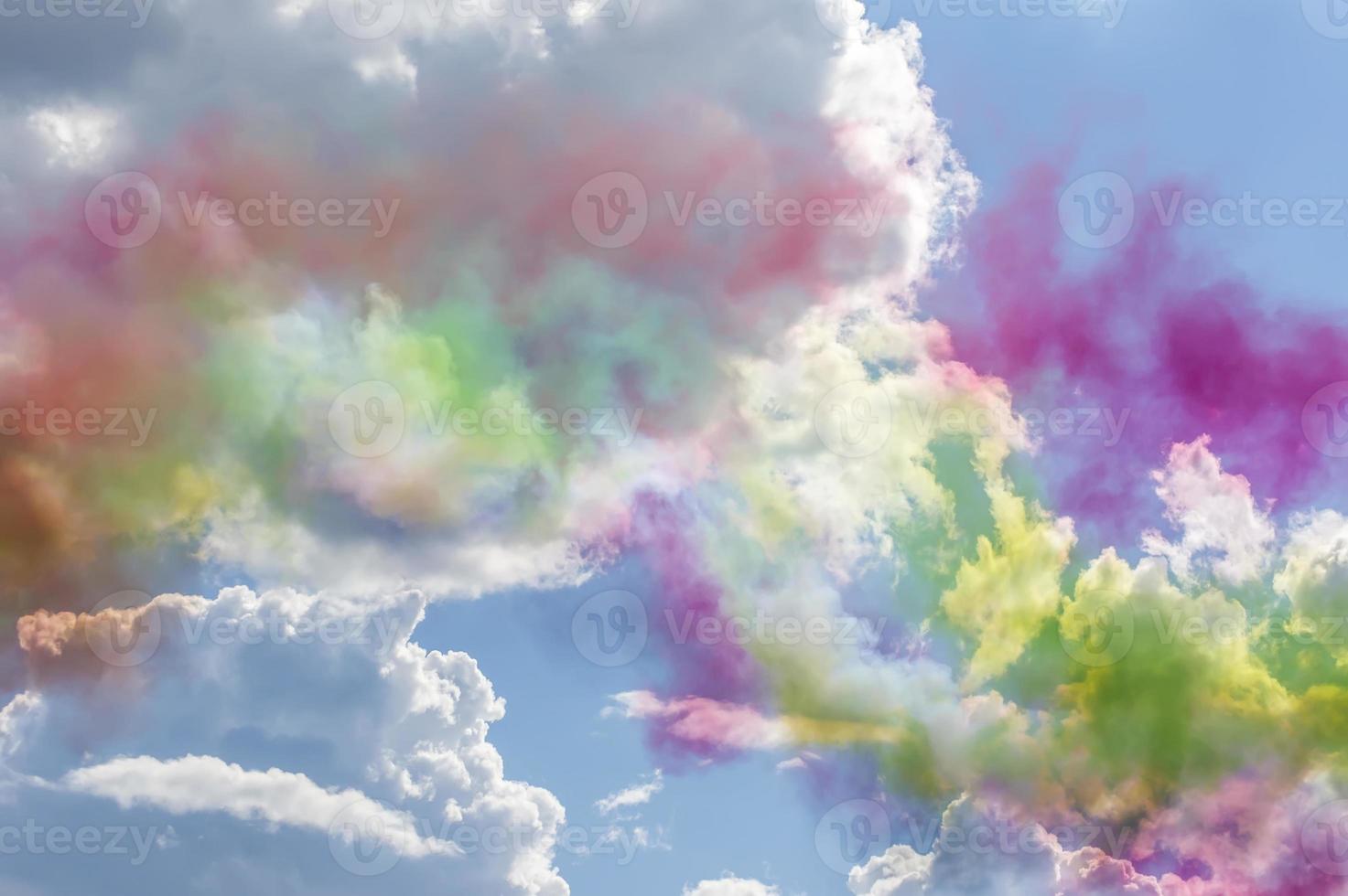 Colorful smoke in blue sky with clouds photo