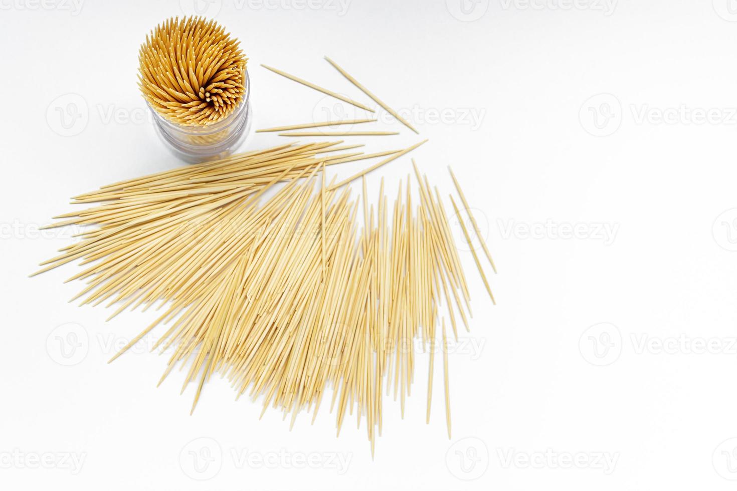 Pile of round wooden toothpicks on white background. Copy space. photo