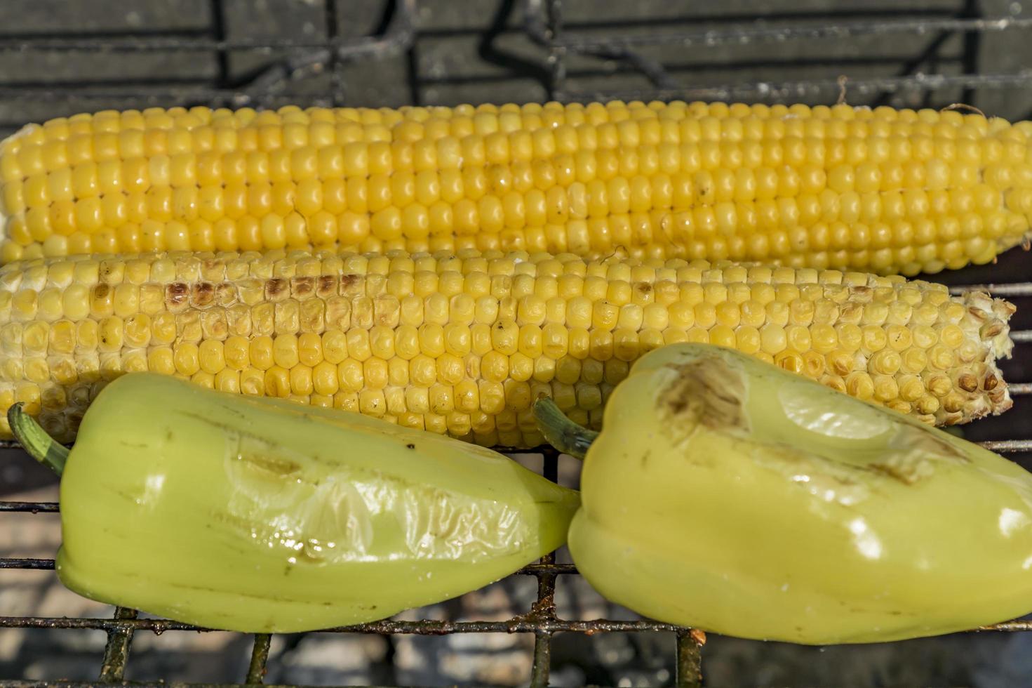 closeup of corn and paprika on grill photo